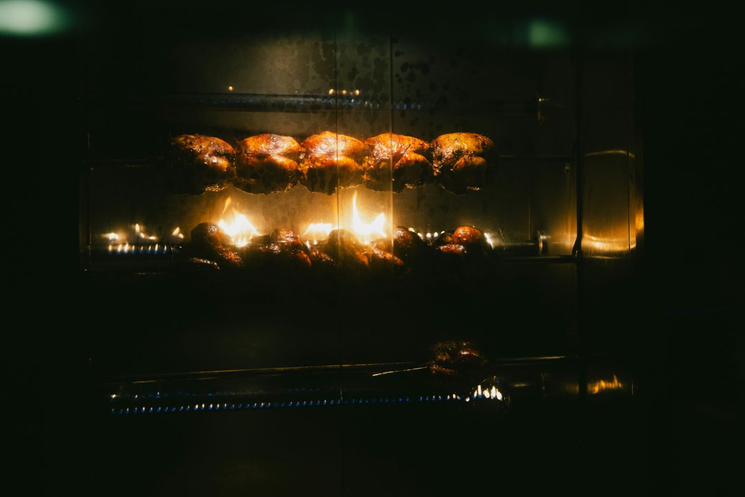 Rotisserie chickens in an oven | Source: Unsplash