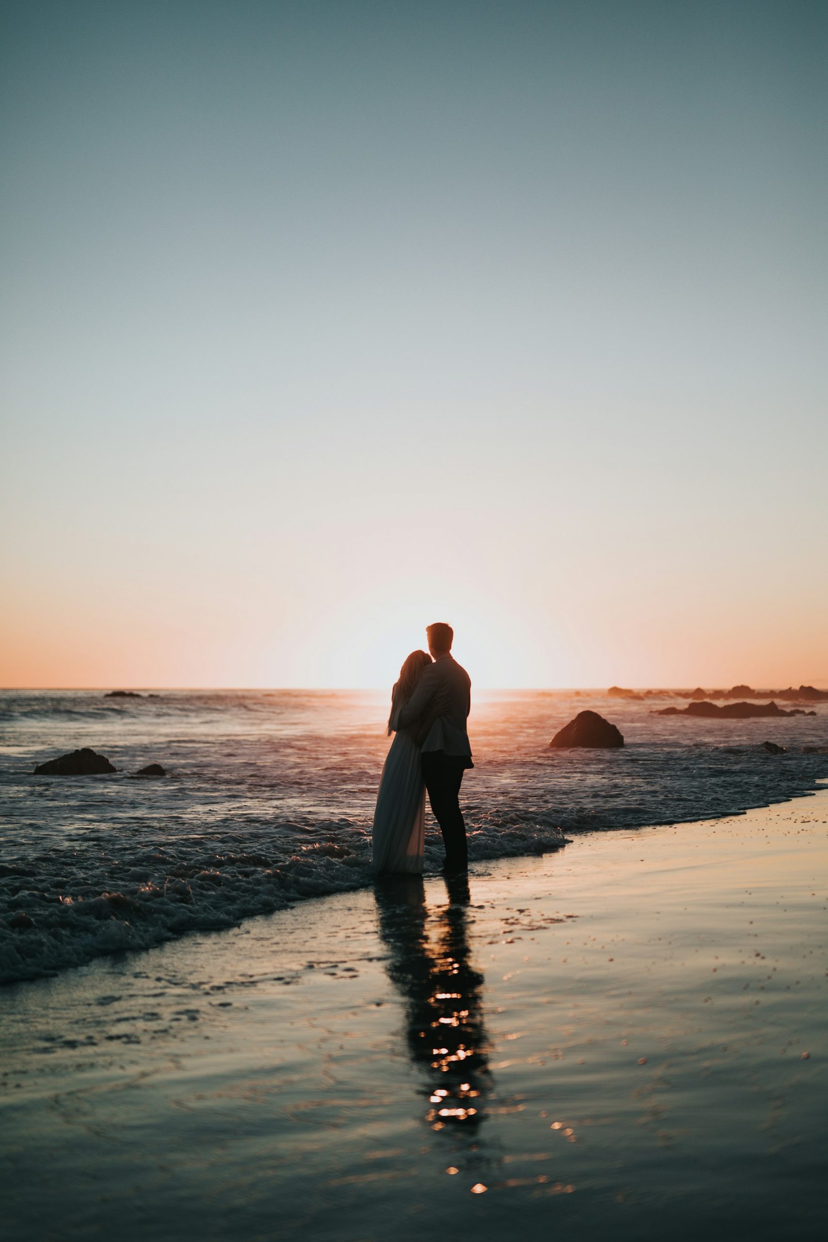 A couple embracing each other at the beach | Source: Unsplash