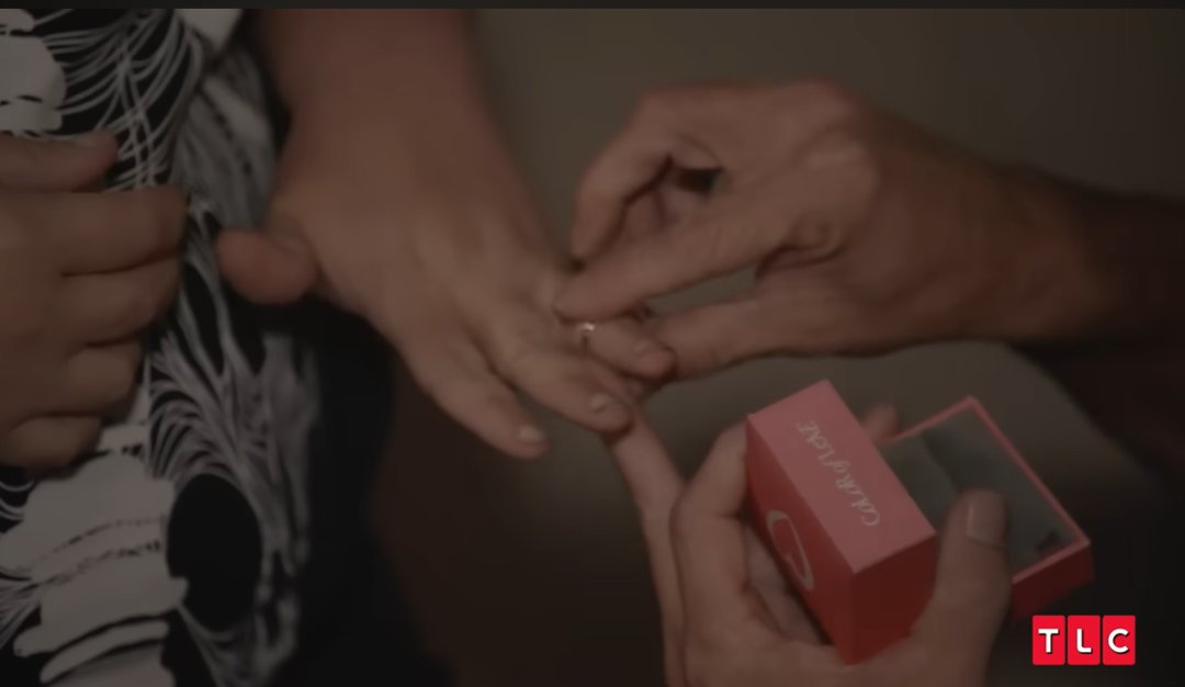 Brian Lovvorn places the engagement ring on Amy Slaton's finger after she accepts the proposal, as posted on July 7, 2025 | Source: YouTube/TLC