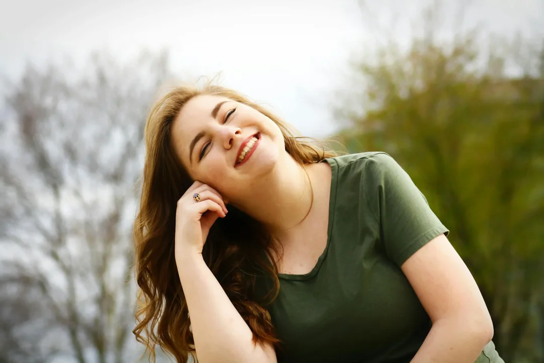 A smiling woman in a park | Source: Pexels
