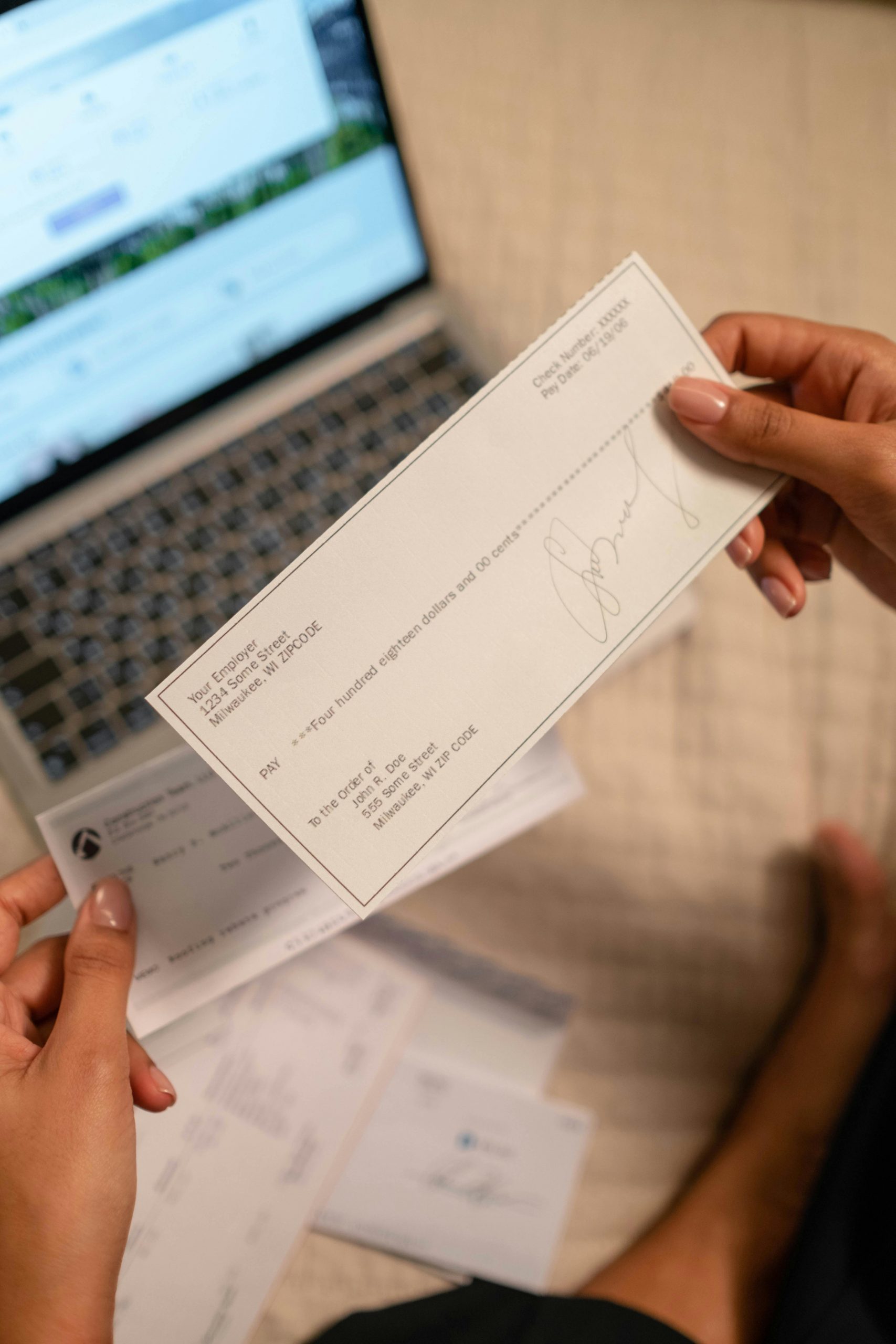 A woman holding a check | Source: Pexels
