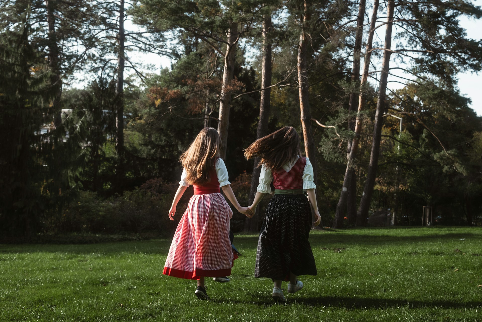 Two best friends holding hands and walking together | Source: Unsplash