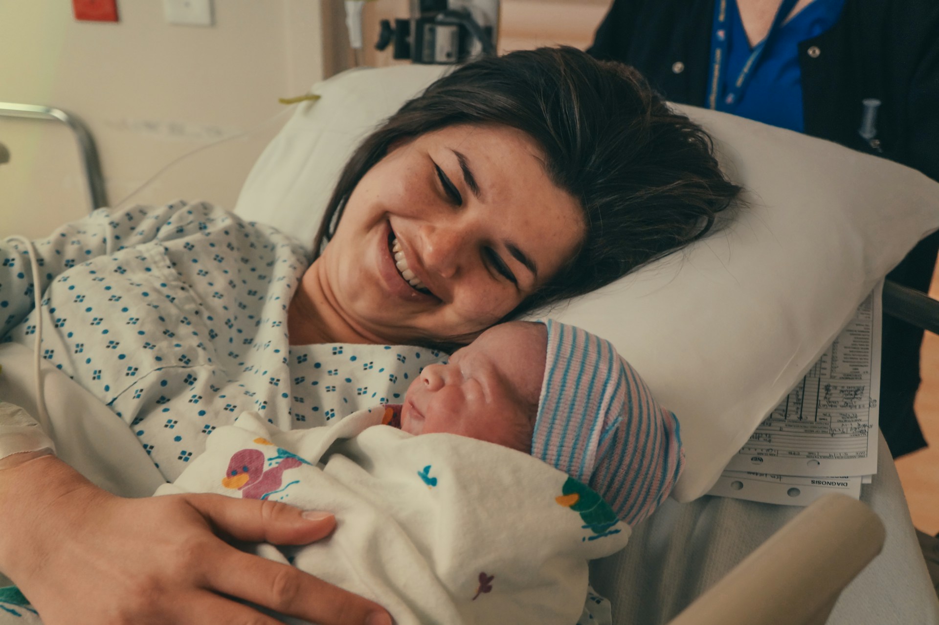 A delighted mother with her newborn baby | Source: Unsplash
