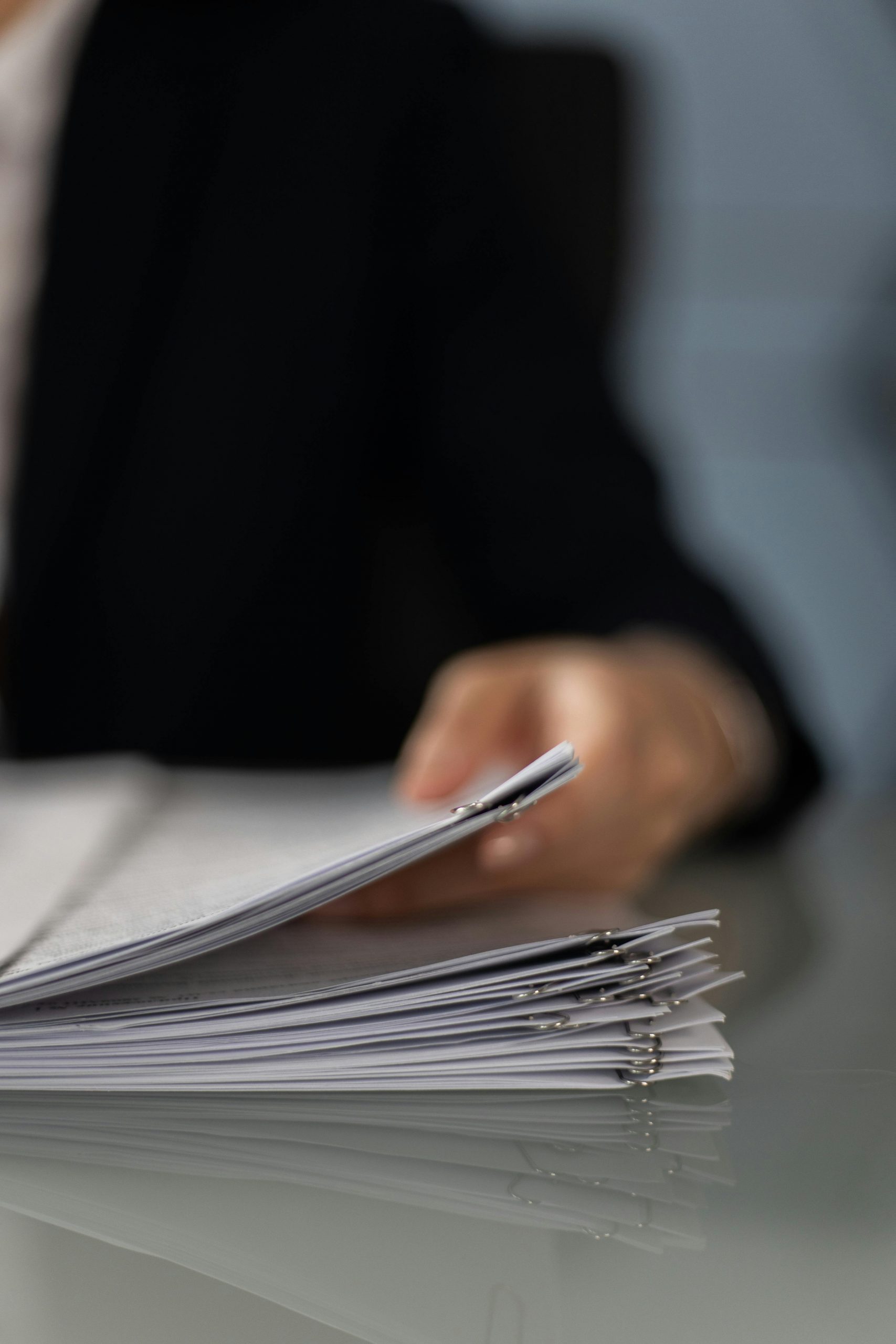 Close-up of a person holding paperwork | Source: Pexels