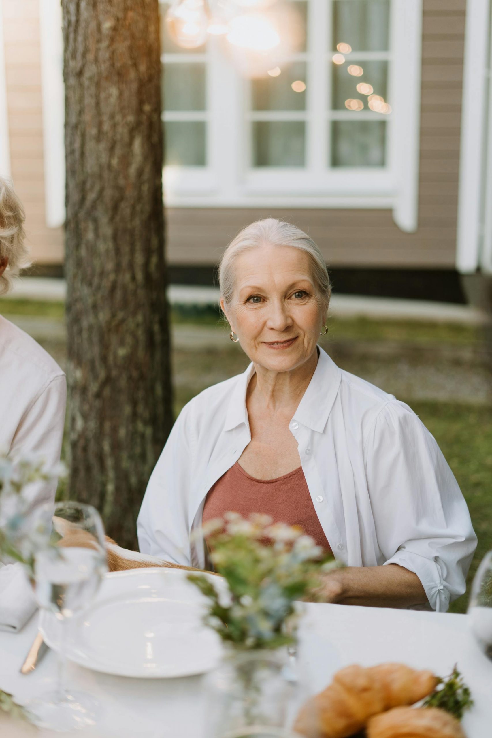 A mature woman seated at a dining table | Source: Pexels