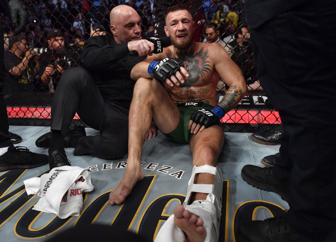 Conor McGregor of Ireland is interviewed by Joe Rogan after his TKO loss due to injury against Dustin Poirier in their welterweight fight during the UFC 264 event at T-Mobile Arena on 10 July 2021 in Las Vegas, Nevada. | Source: Getty Images