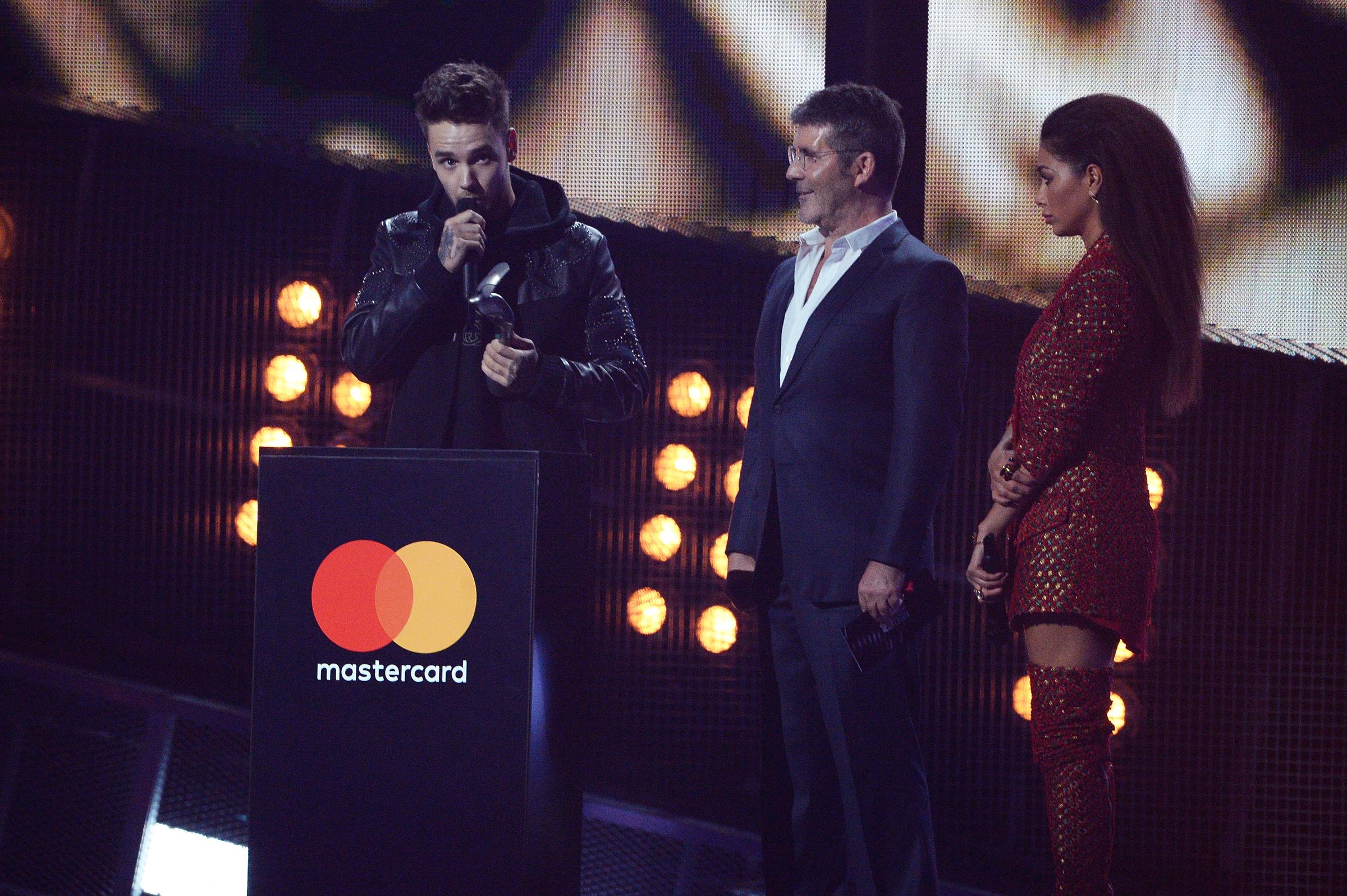 Liam Payne, Simon Cowell, and Nicole Scherzinger on stage at The Brit Awards 2017 on February 22 in London, England. | Source: Getty Images