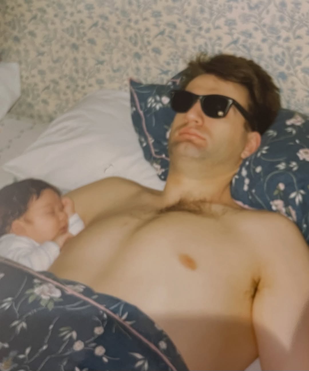 Safe in his arms. A young Douglas is nestled on his father's chest — the kind of peace only a parent can bring. Sunglasses on, heart wide open — dad mode, always on. | Source: Instagram/douglasbooth