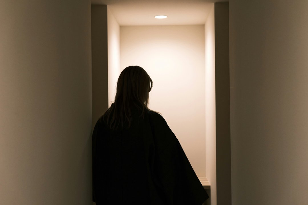 A woman about to exit a room | Source: Unsplash