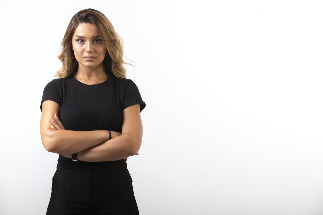 A serious woman with folded arms | Source: Freepik