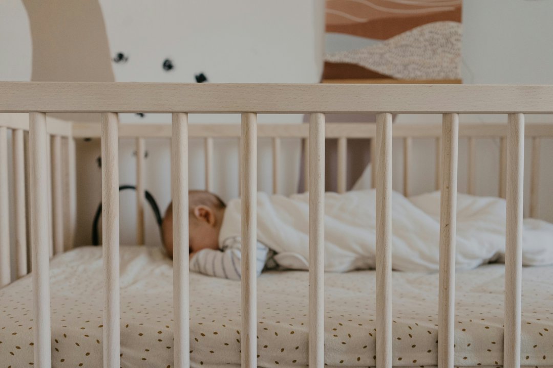 A baby sleeping in a crib | Source: Unsplash