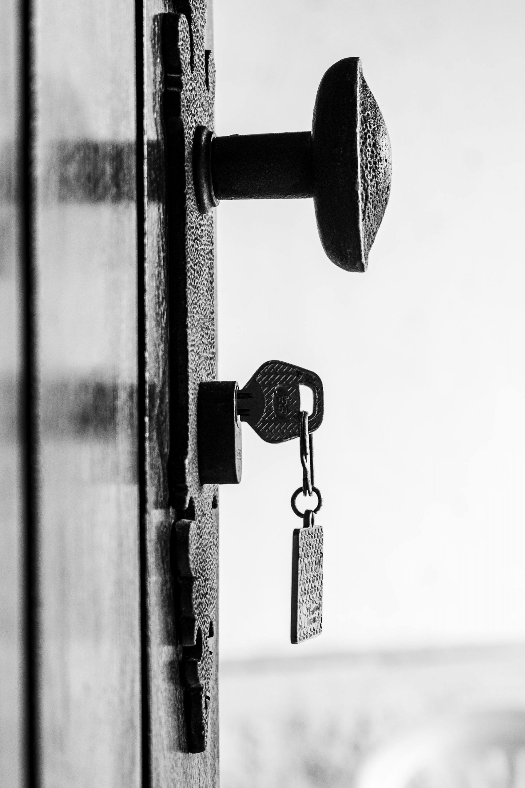 A vintage key inserted in a lock on a rustic door | Source: Pexels