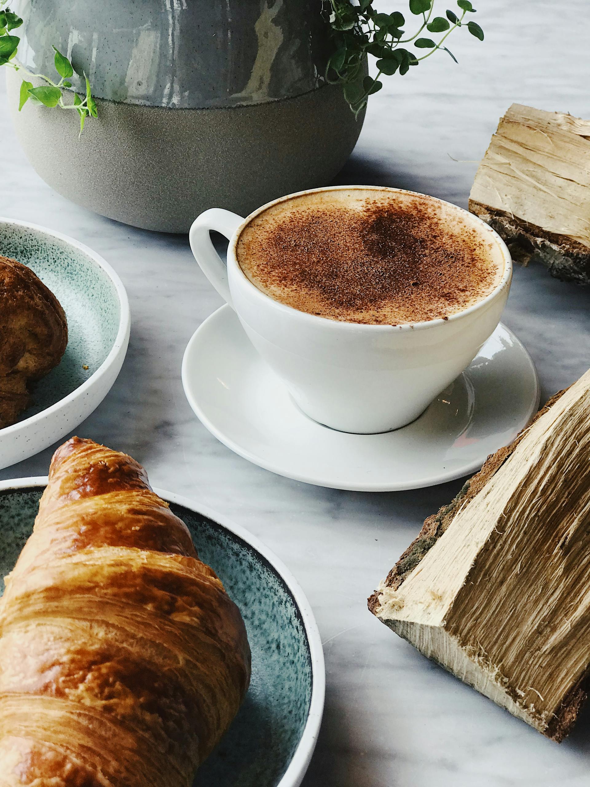 Croissant and coffee served on a table | Source: Pexels