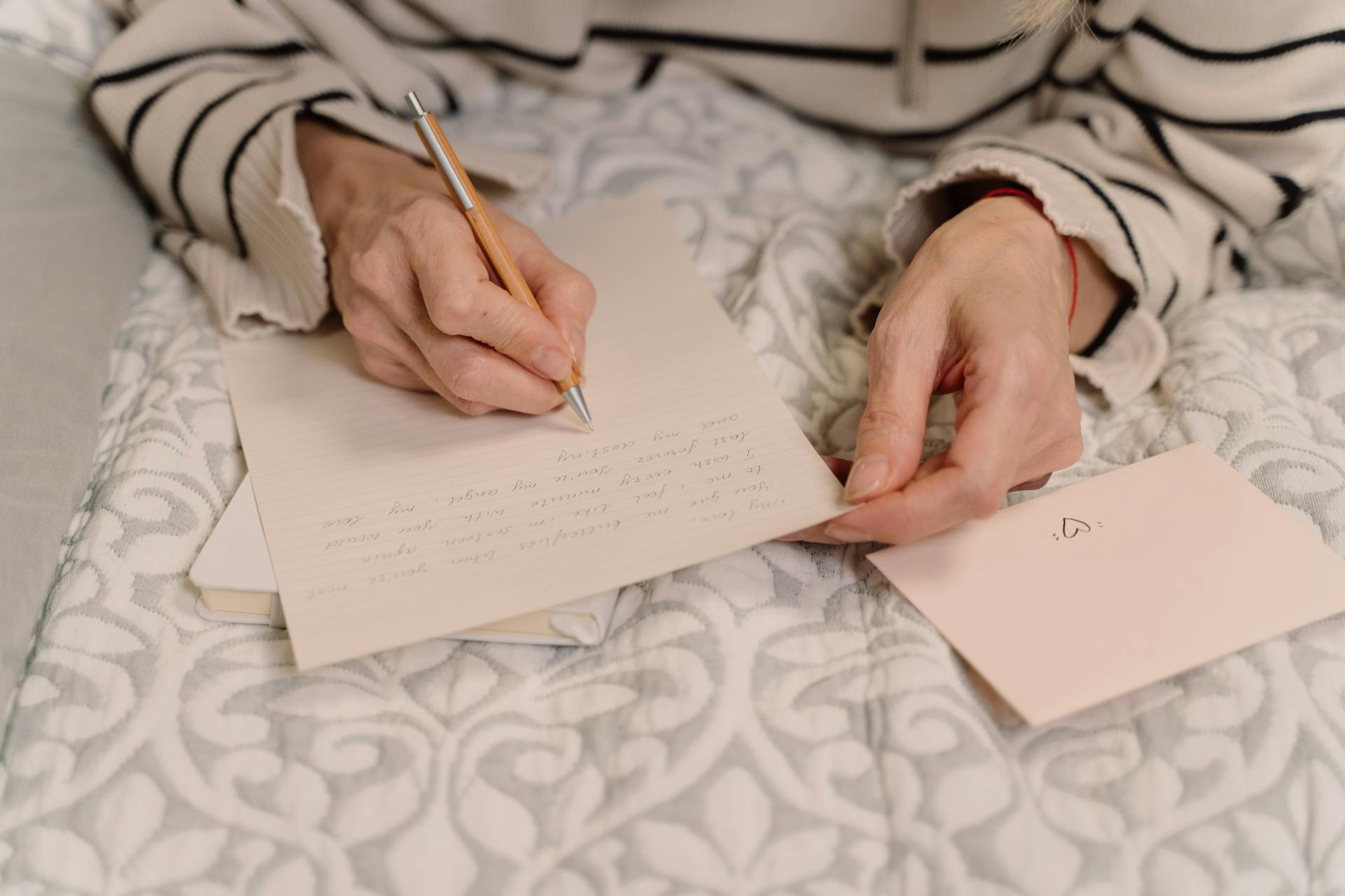 Close-up shot of a woman writing a letter | Source: Pexels