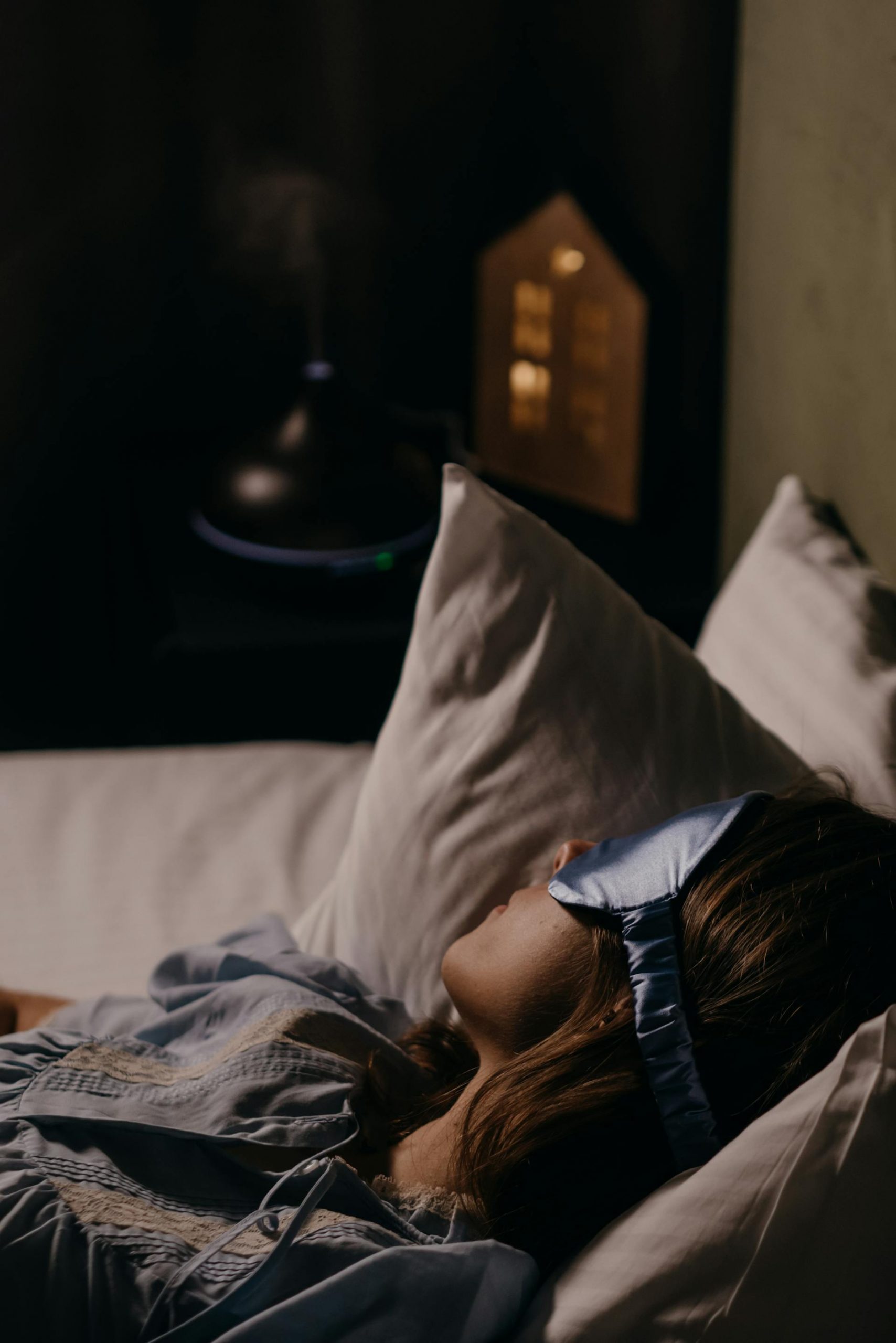 A woman sleeping while wearing an eye mask | Source: Pexels