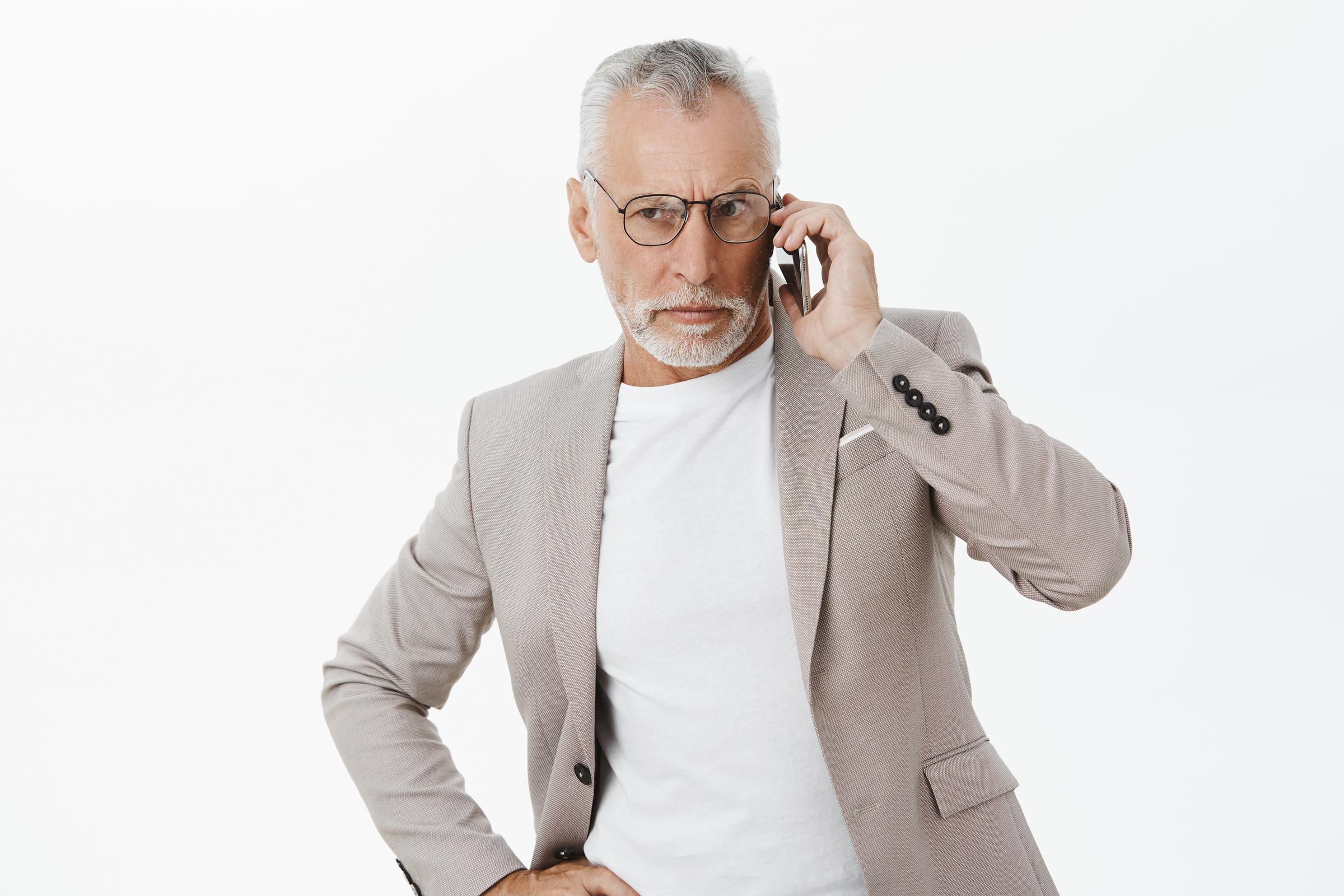 An upset man on a call | Source: Freepik