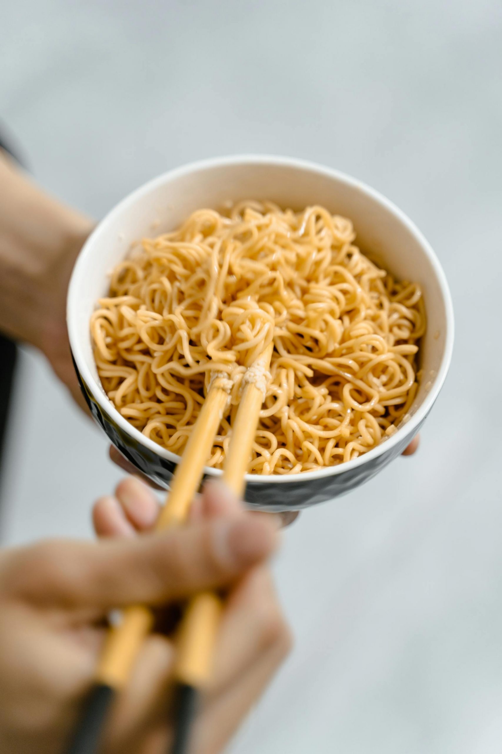 A person holding a bowl of noodles | Source: Pexels
