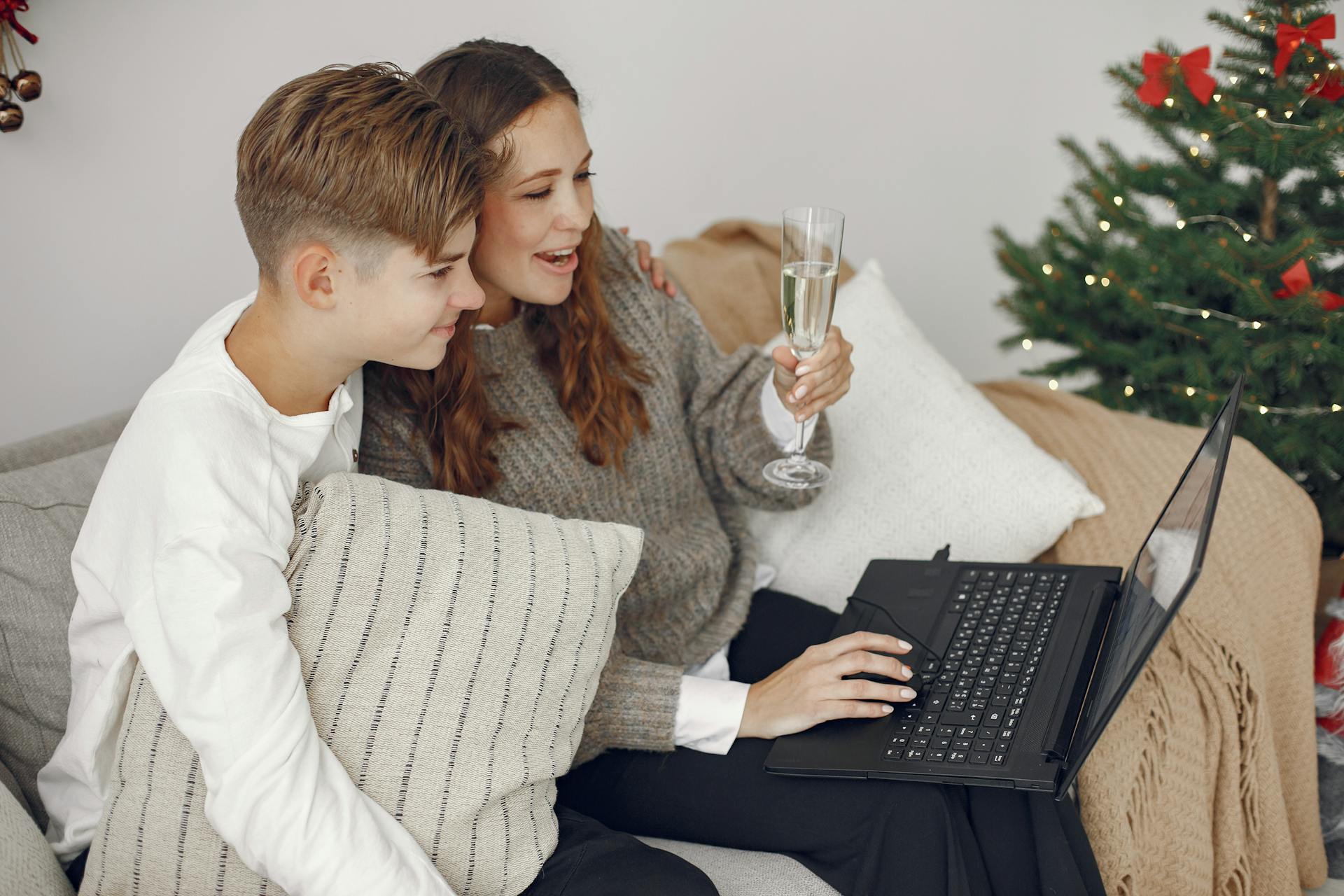 A woman and her young son sitting together and looking at the laptop screen | Source: Pexels