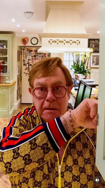 Sir Elton John opens a kitchen cabinet — and instantly freezes in horror as