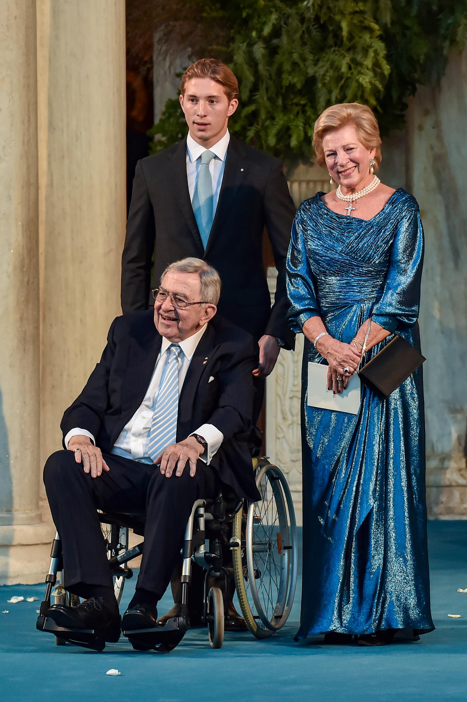 Dressed in formal attire, Prince Constantine-Alexios stood behind his grandparents, King Constantine II and Queen Anne-Marie of Greece, as they left the Metropolis Greek Orthodox Cathedral in Athens following the wedding of Prince Philippos and Nina Flohr on October 23, 2021.