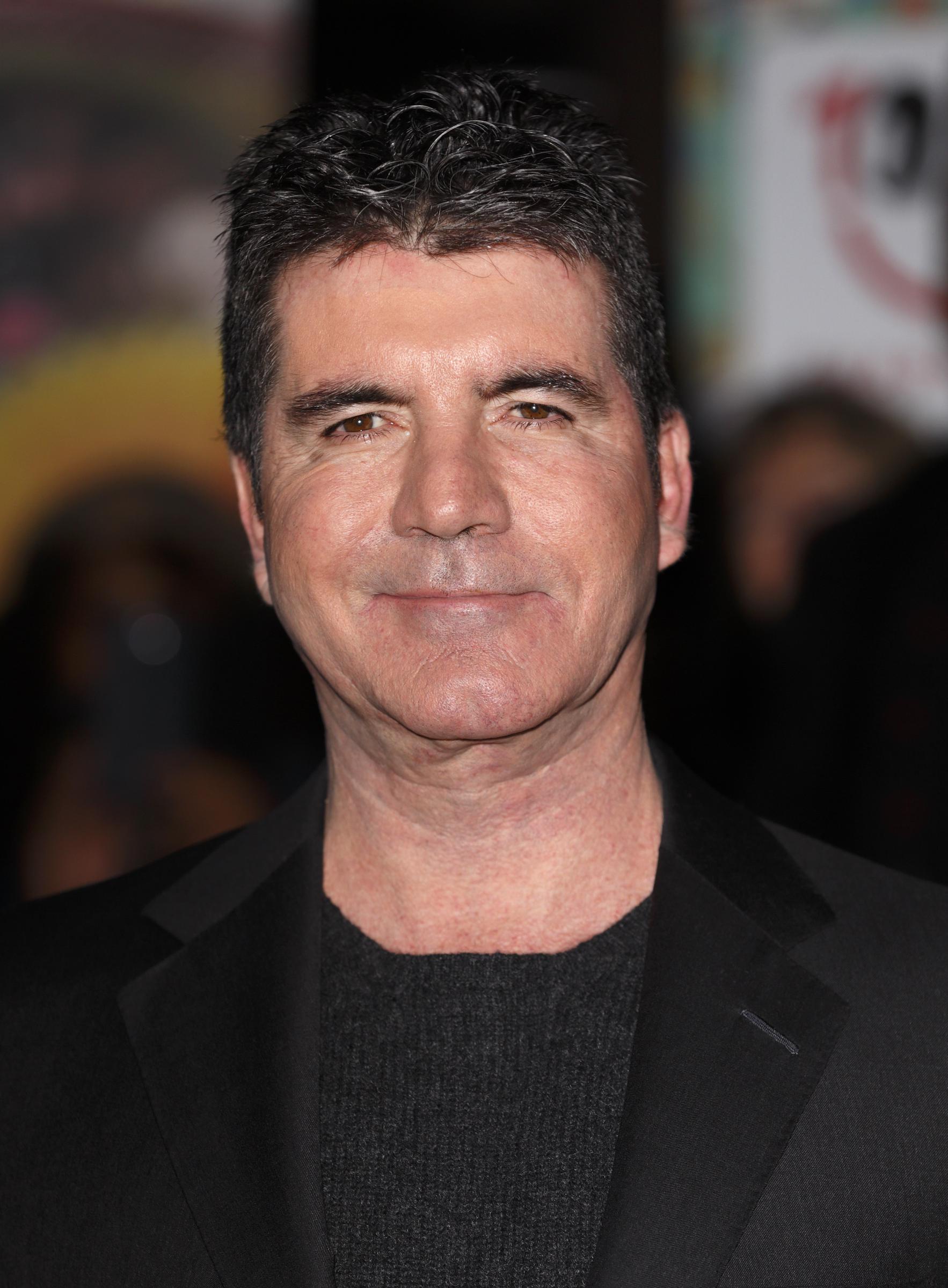 Fast forward to 2014, and Cowell steps onto the ICAP Charity Day floor in London with a pared-down look &mdash; no tie, just confidence. The understated blazer and crew neck mark a new era of laid-back authority.