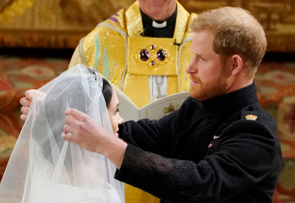 Prince Harry lifts Meghan Markle’s veil during their wedding ceremony at St. George's Chapel, Windsor Castle, on May 19, 2018 | Source: Getty Images