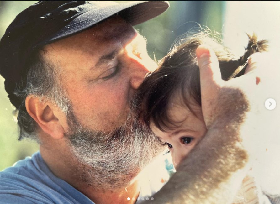 Rob Reiner kisses a young Romy's head, from a post dated March 6, 2022. | Source: Instagram/romyreiner