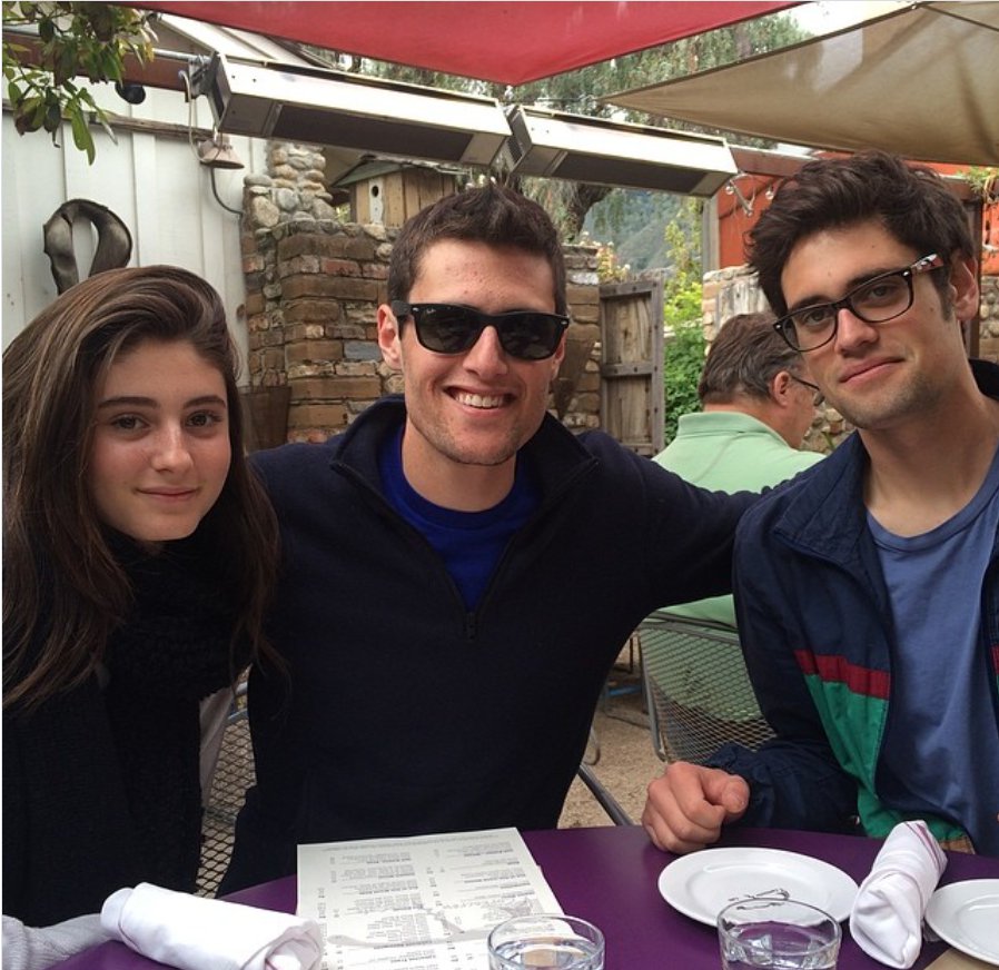 Jake Reiner sits with his siblings, Romy and Nick, at an outdoor restaurant in a post dated May 11, 2014. | Source: Instagram/michelereiner