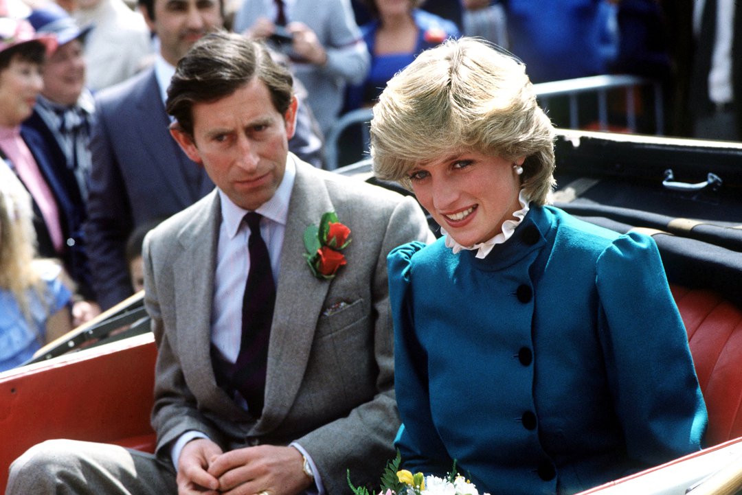 A fresh-faced Princess Diana smiles warmly from an open-top carriage as she visits St Columb, Cornwall, in May 1983. Dressed in a green wool suit and cream ruffled blouse, she is joined by Prince Charles as crowds line the streets to greet the royals.