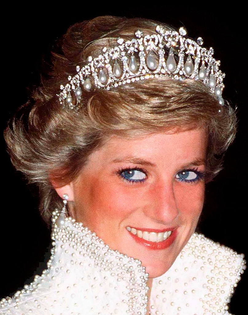 All eyes are on Princess Diana as she dazzles in a pearl-and-diamond tiara during a 1989 engagement in Hong Kong. Wearing a shimmering pearl-embellished gown &mdash; a symbol of her unrivaled elegance &mdash; she once again confirms her title as a global style icon.