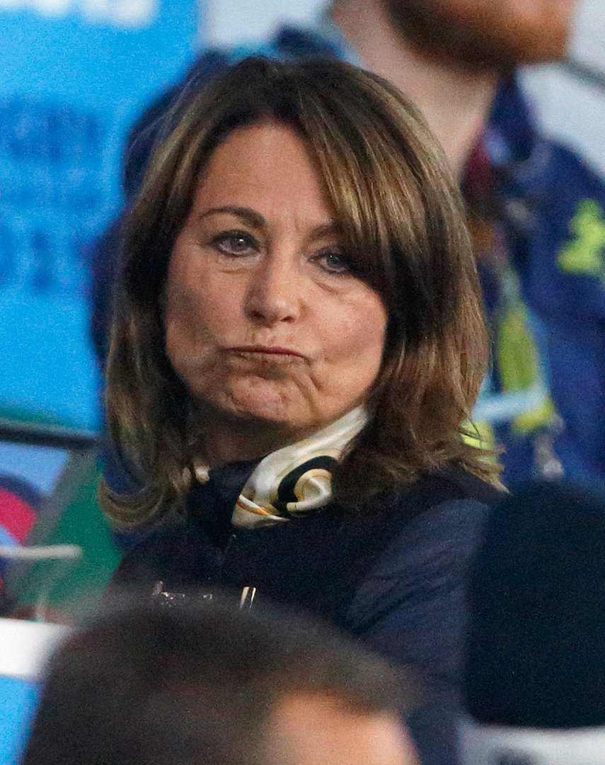 Bundled in a dark coat and scarf, Carole Middleton watches intently from the stands at Twickenham during the Rugby World Cup on 3 October 2015. The mother of the future Queen stands shoulder-to-shoulder with fellow fans as England faces off against Australia.