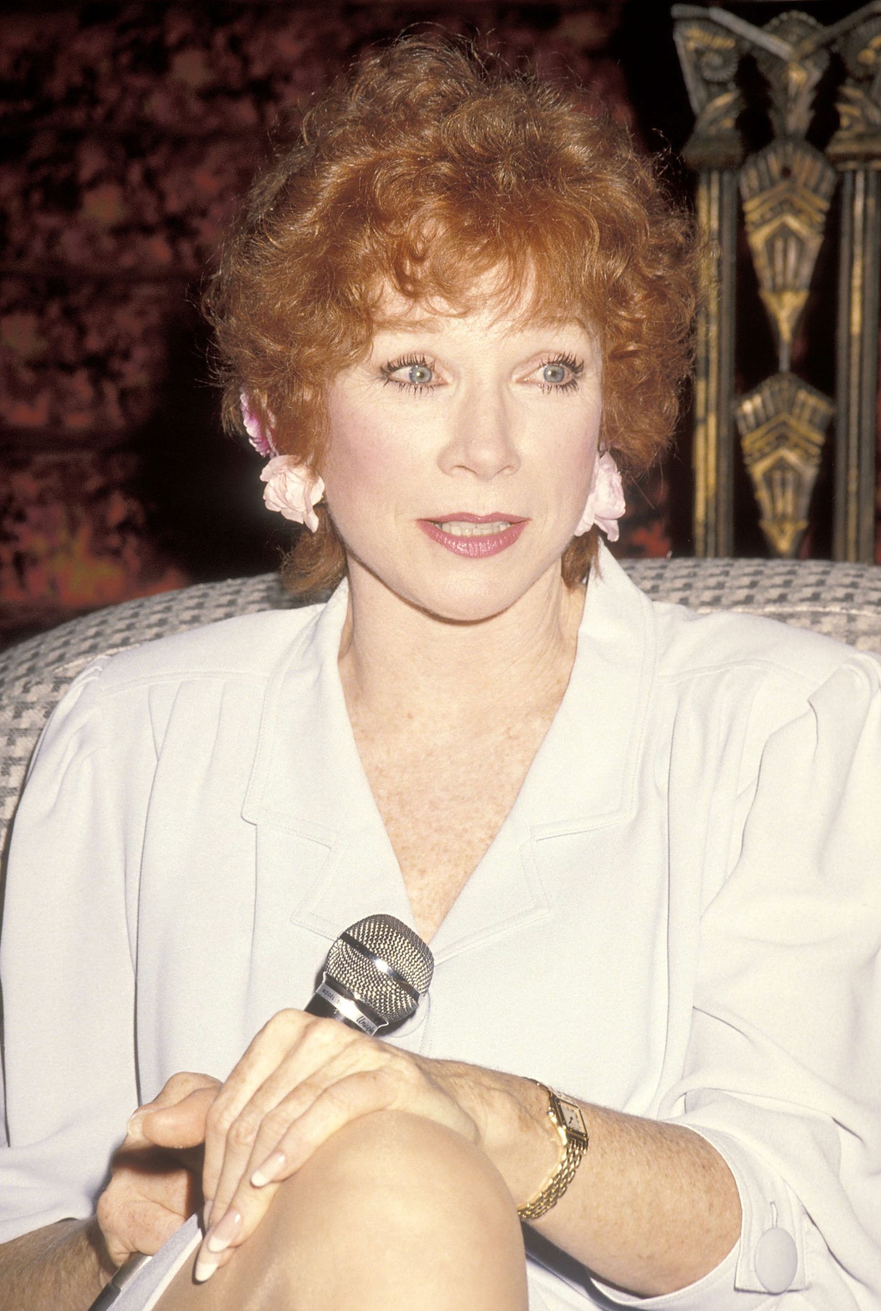 Poised and pensive, MacLaine speaks at the 1990 
