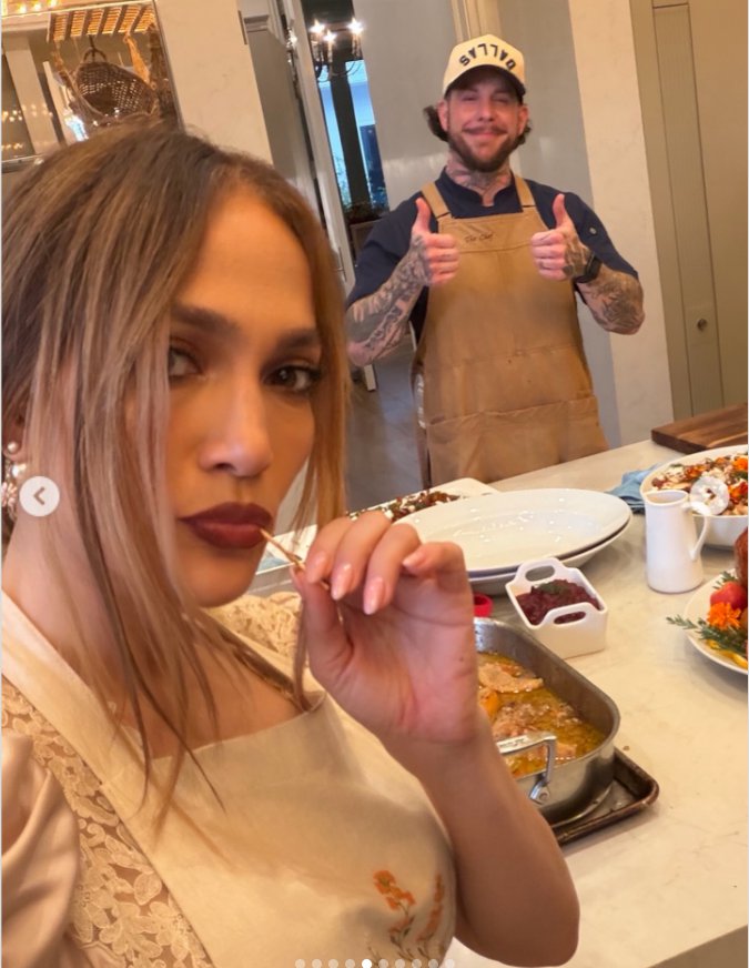Jennifer Lopez in an apron takes a photo with a man who is also wearing an apron, as seen in a post dated November 28, 2025. | Source: Instagram/jlo