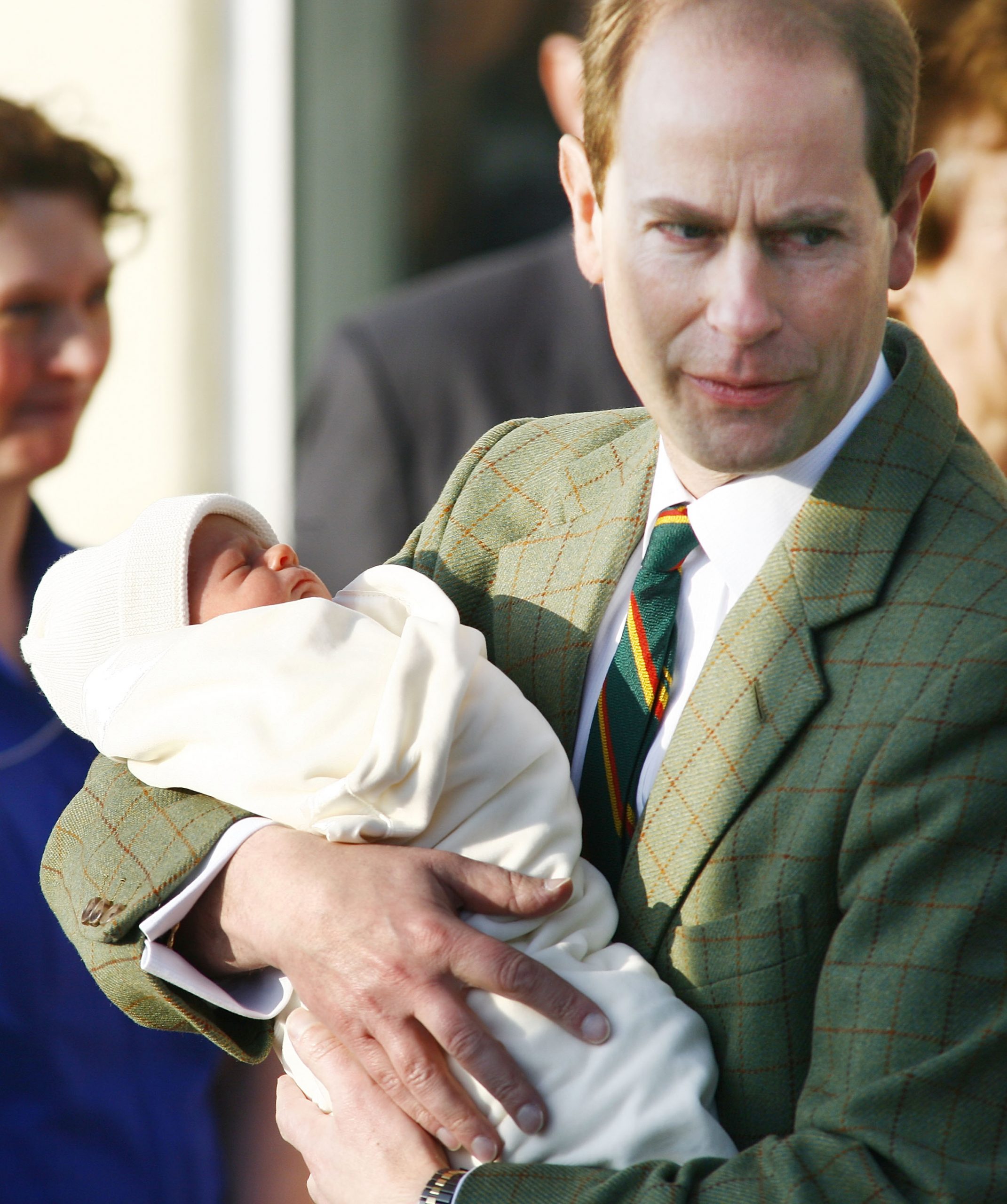 A tender moment between new parents: Prince Edward, then Earl of Wessex, gently cradles baby James as he and Sophie, then Countess of Wessex, leave Frimley Park Hospital in Surrey on 20 December 2007. Swaddled in a soft white blanket, the newborn marked a joyous chapter for the royal couple.