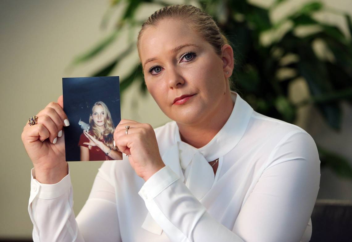 Virginia Giuffre photographed on March 1, 2023, with a picture of herself as a teen, when she was allegedly abused by Jeffrey Epstein, Ghislaine Maxwell, and Andrew Mountbatten-Windsor, among others. | Source: Getty Images