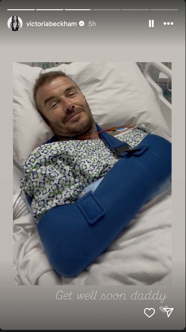 Sir David Beckham lying in a hospital bed with his arm in a sling, posted via Instagram Stories in June 2025. | Source: Instagram/victoriabeckham