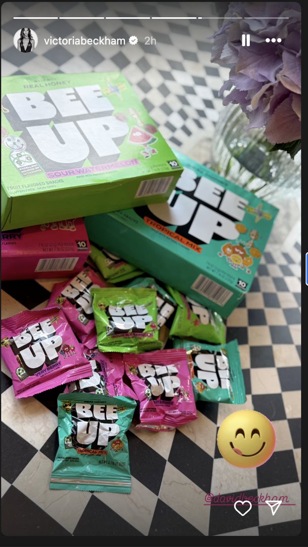 Some sweet treats lying next to a vase full of lilac flowers. | Source: Instagram/victoriabeckham