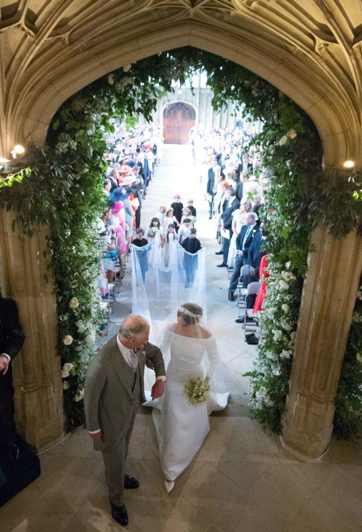 Meghan Markle walks up the aisle with then-Prince Charles at St George's Chapel at Windsor Castle during her wedding to Prince Harry on May 19, 2018, in Windsor, England | Source: Getty Images
