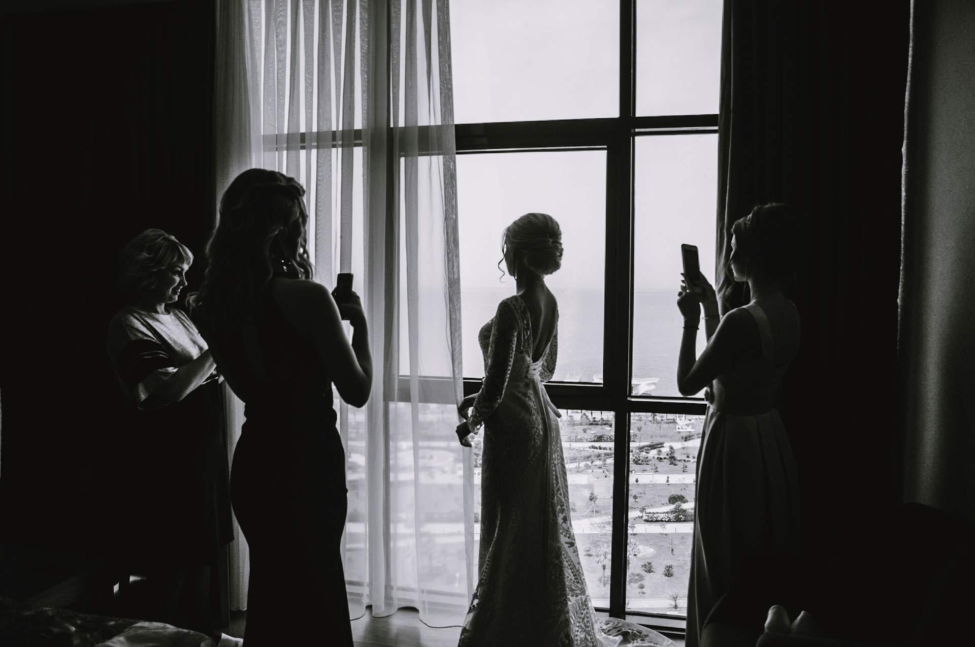 Women taking photos of a bride in her suite | Source: Unsplash
