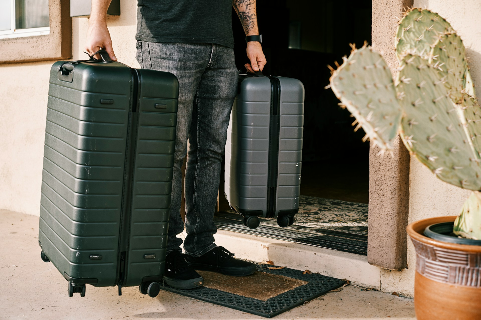 A man holding two suitcases | Source: Unsplash