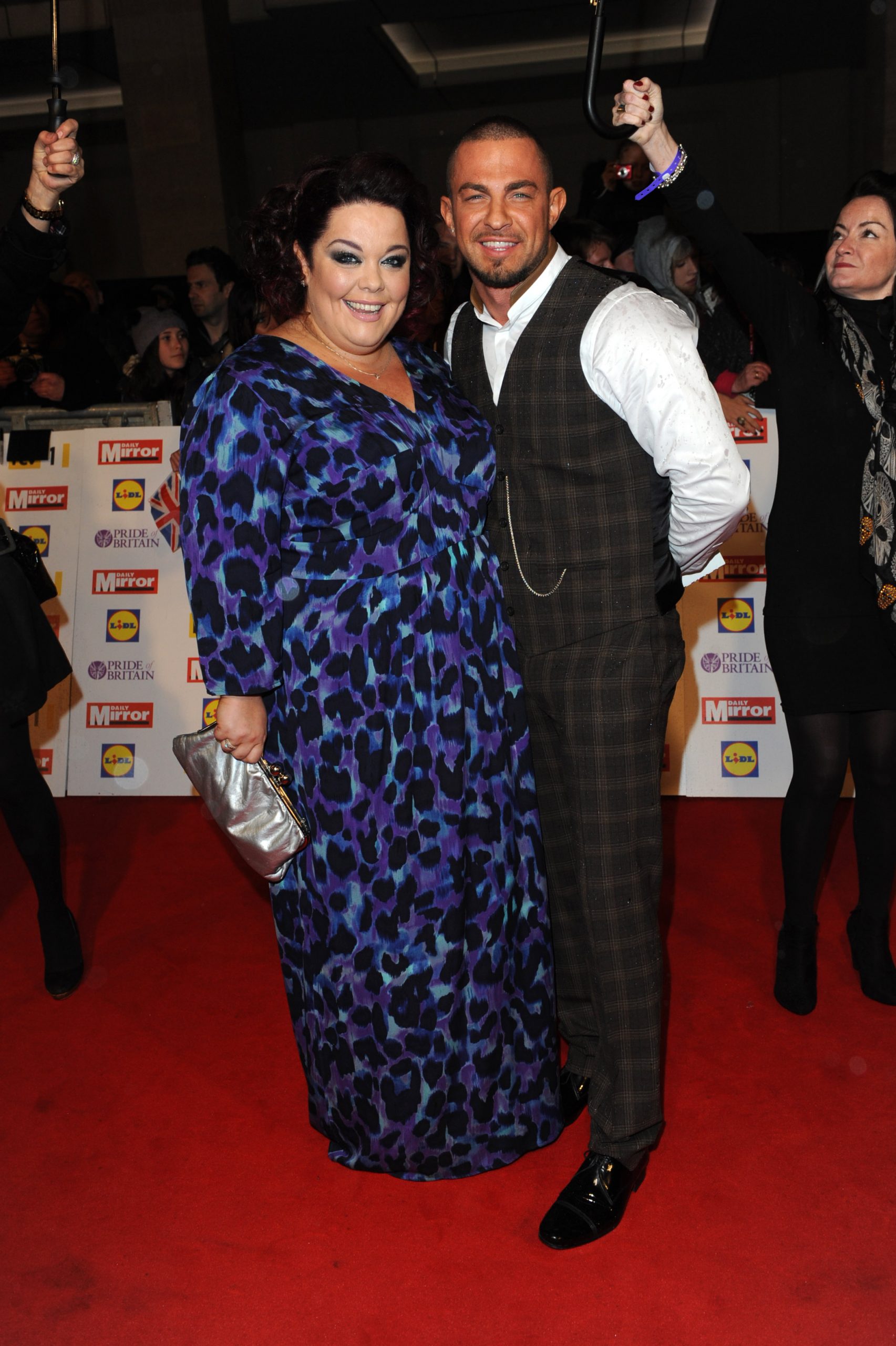 Red carpet royalty! Riley and Strictly partner Robin Windsor dazzle at the Pride of Britain Awards on 29 October 2012. Riley stuns in a vibrant blue-and-purple print gown, while Windsor turns heads in a sharp checked suit at the glittering Grosvenor House gala.