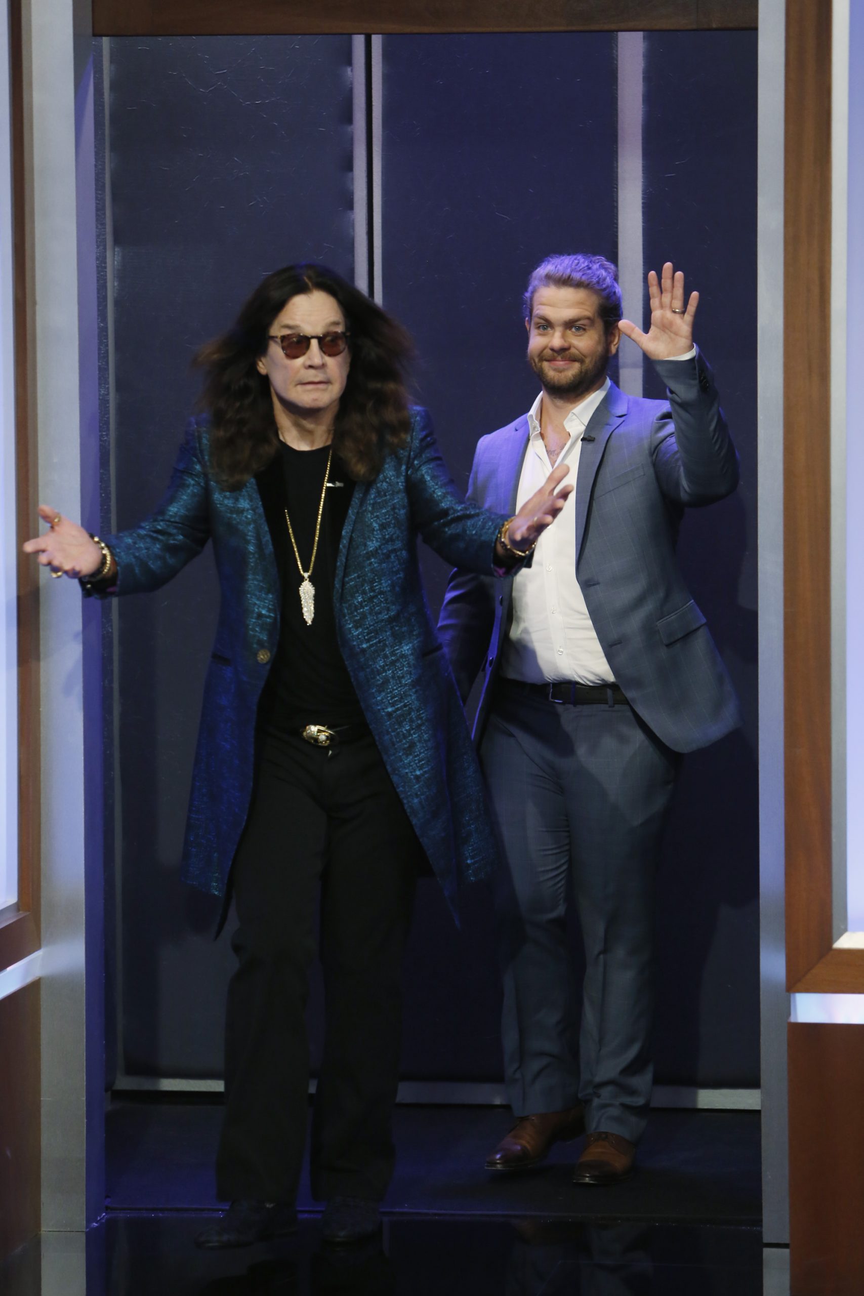 Ozzy Osbourne walks out with arms spread as his son Jack waves to the crowd during their appearance on Jimmy Kimmel Live! in Los Angeles on 11 April 2016.