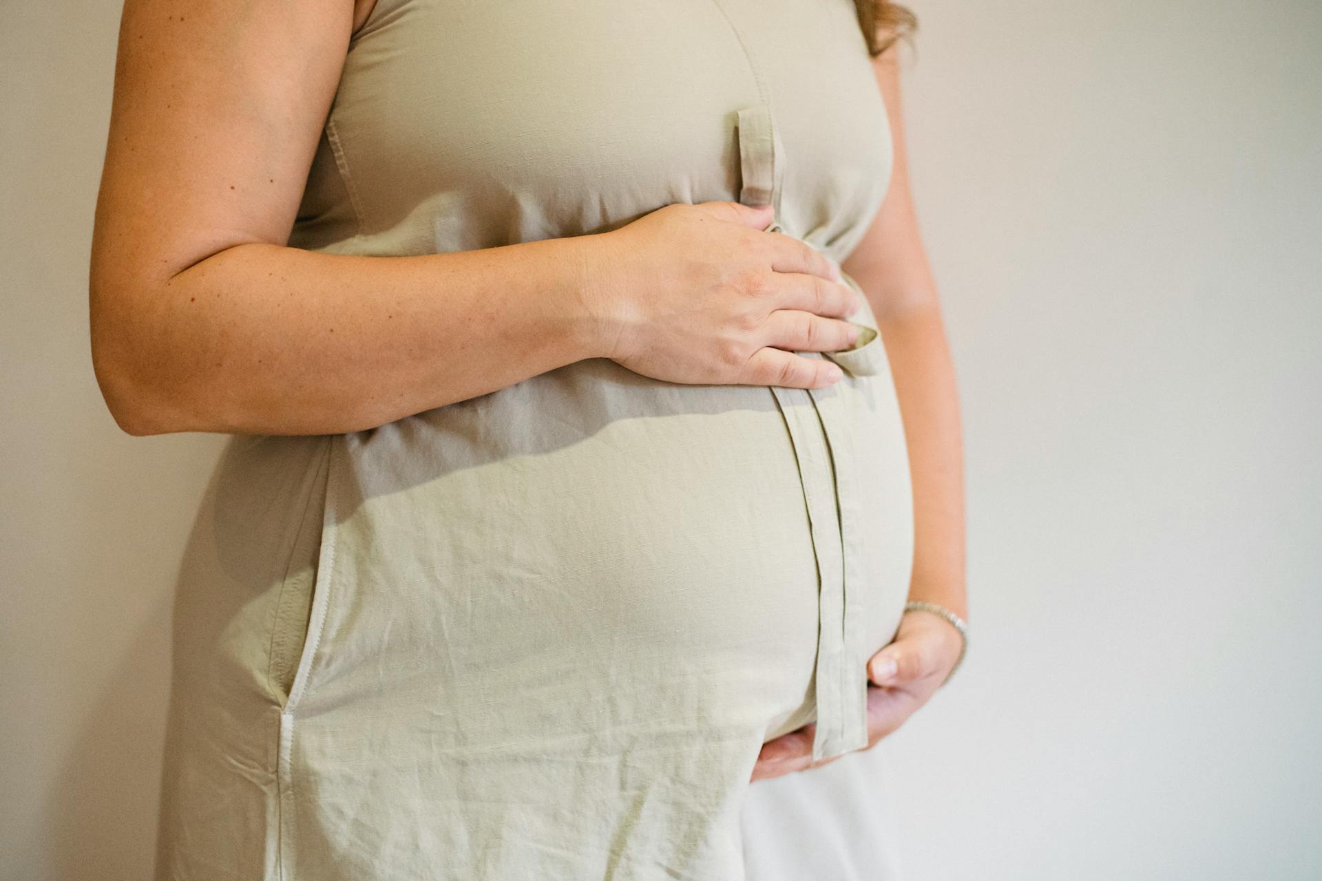 A pregnant woman holding her baby bump | Source: Pexels