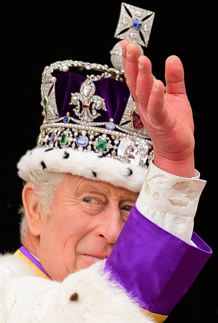 Britain's King Charles III wearing the Imperial state Crown, waves from the Buckingham Palace balcony on May 6, 2023, after his coronation. | Source: Getty Images