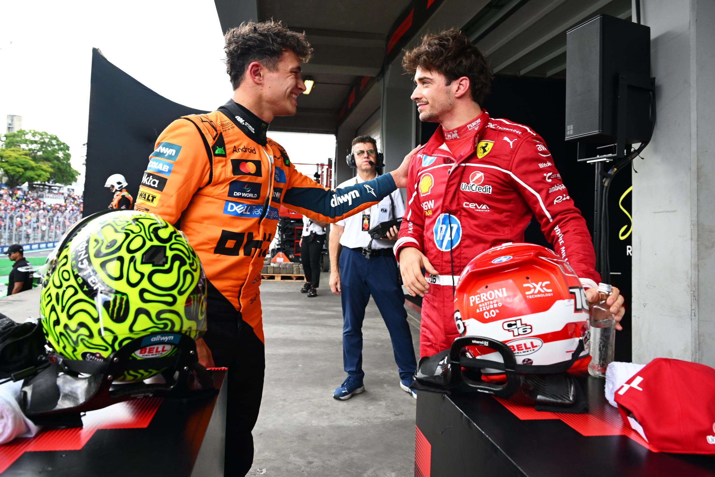 Lando Norris of Great Britain and Third placed qualifier Charles Leclerc of Monaco talk ahead of the F1 Grand Prix of Brazil at Autodromo Jose Carlos Pace on November 08, 2025 in Sao Paulo, Brazil. | Source: Getty Images