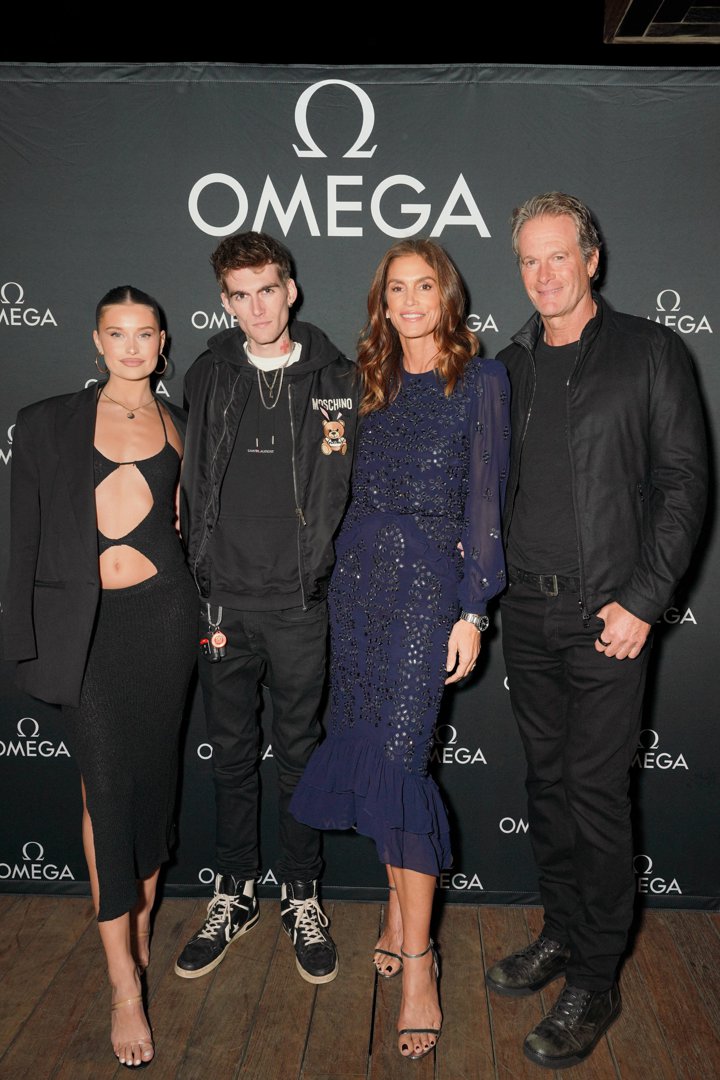 Lexi Wood, Presley Gerber, Cindy Crawford, and Rande Gerber posed together at the Haute Living Celebrates Cindy Crawford With OMEGA event in Malibu, California, on November 3, 2022. Presley, now heavily tattooed and dressed in head-to-toe black with a Moschino bomber jacket and layered chains, stood between his girlfriend and his mother, looking every inch the rebellious figure he had grown into — a striking contrast to the clean-cut boy he once was.