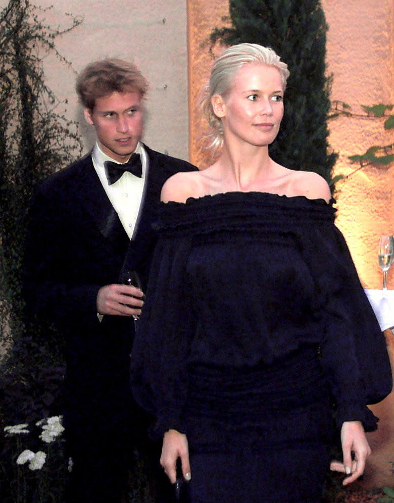 William, Prince of Wales, then in his late teens, appeared to cast a subtle glance just behind Claudia Schiffer as they moved through the evening event at Highgrove. Dressed in a classic black tuxedo with a satin lapel and crisp white shirt, the young royal looked every inch the polished future king, though his expression hinted at a mix of curiosity and quiet admiration.