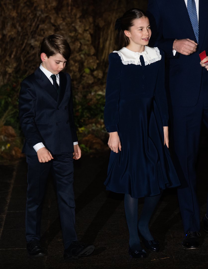 Prince Louis and Princess Charlotte stood side by side in matching navy ensembles, their polished looks and composed presence a subtle reflection of how much they've matured. The young princess's white lace collar and bow added a touch of vintage charm, while the little prince kept close with a shy, downcast gaze.