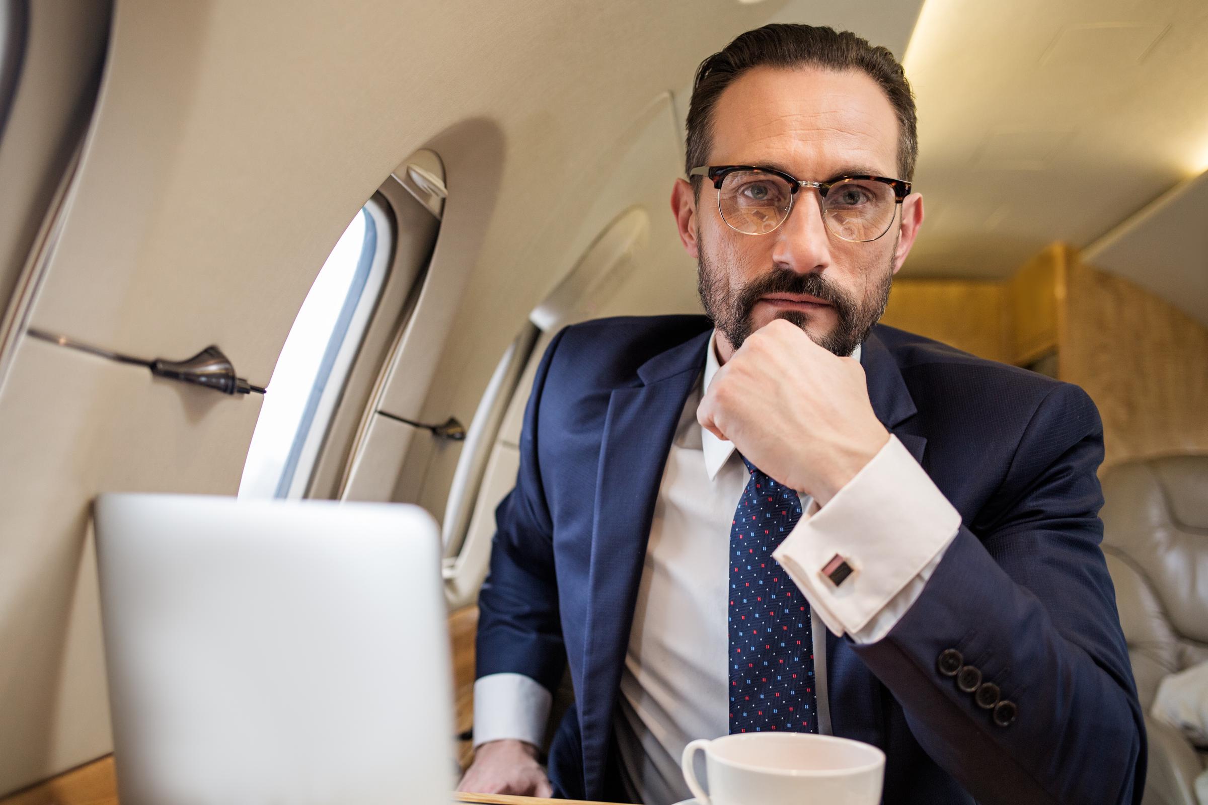 Serious businessman in first class | Source: Shutterstock