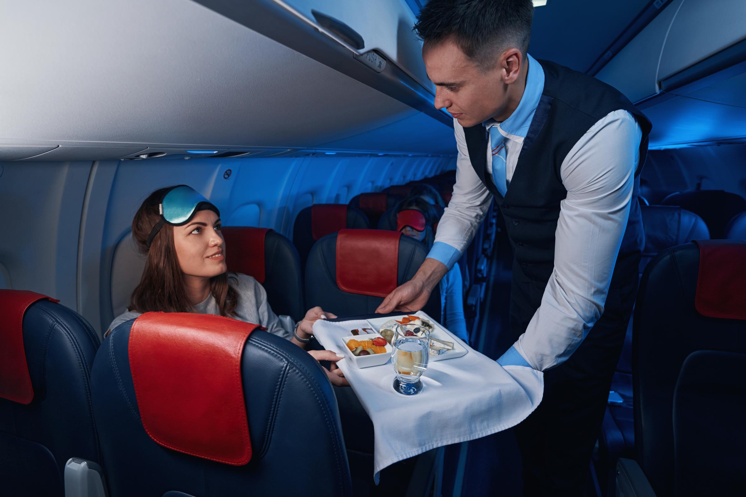 Woman looking at a flight attendant | Source: Shutterstock